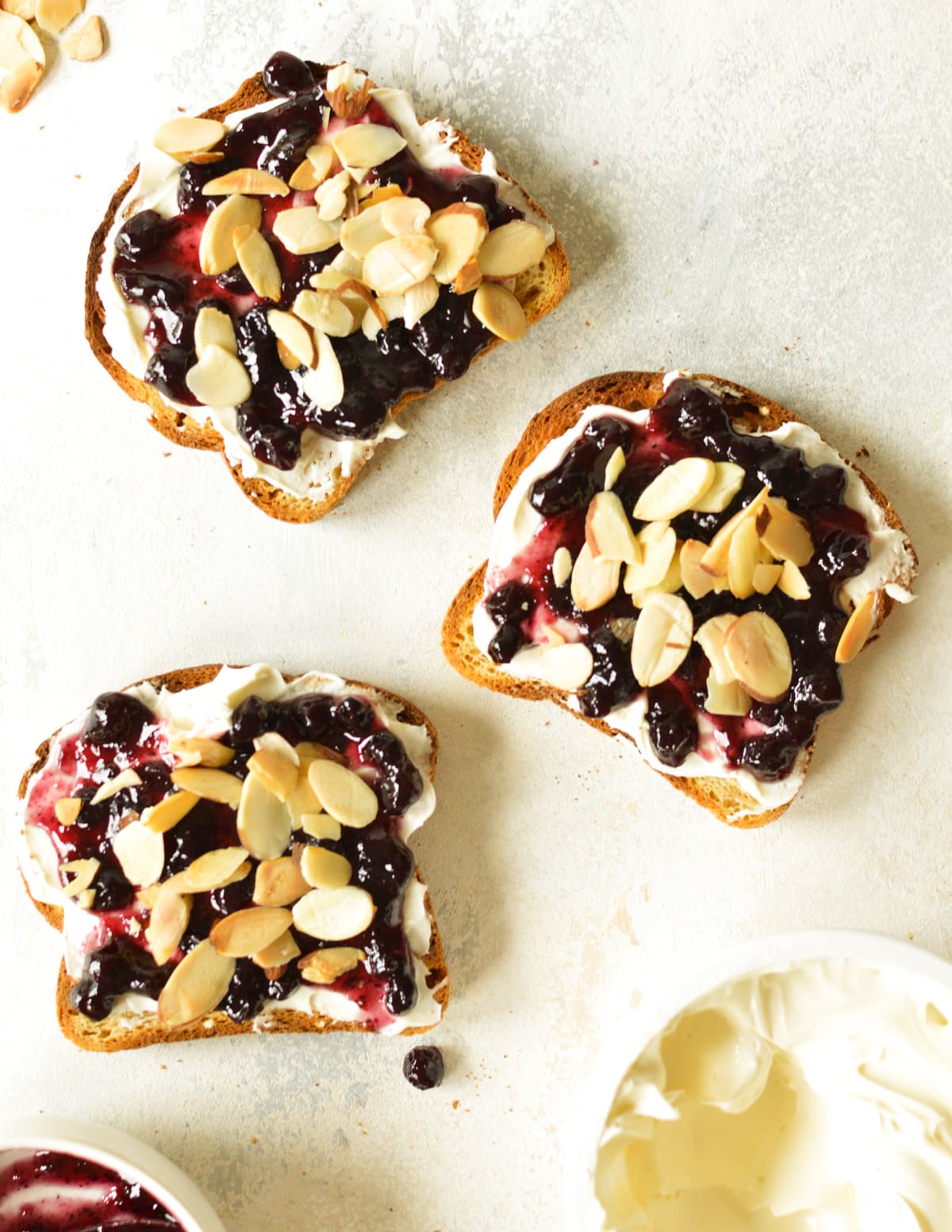 cream cheese, blueberry jam, and almonds on toast