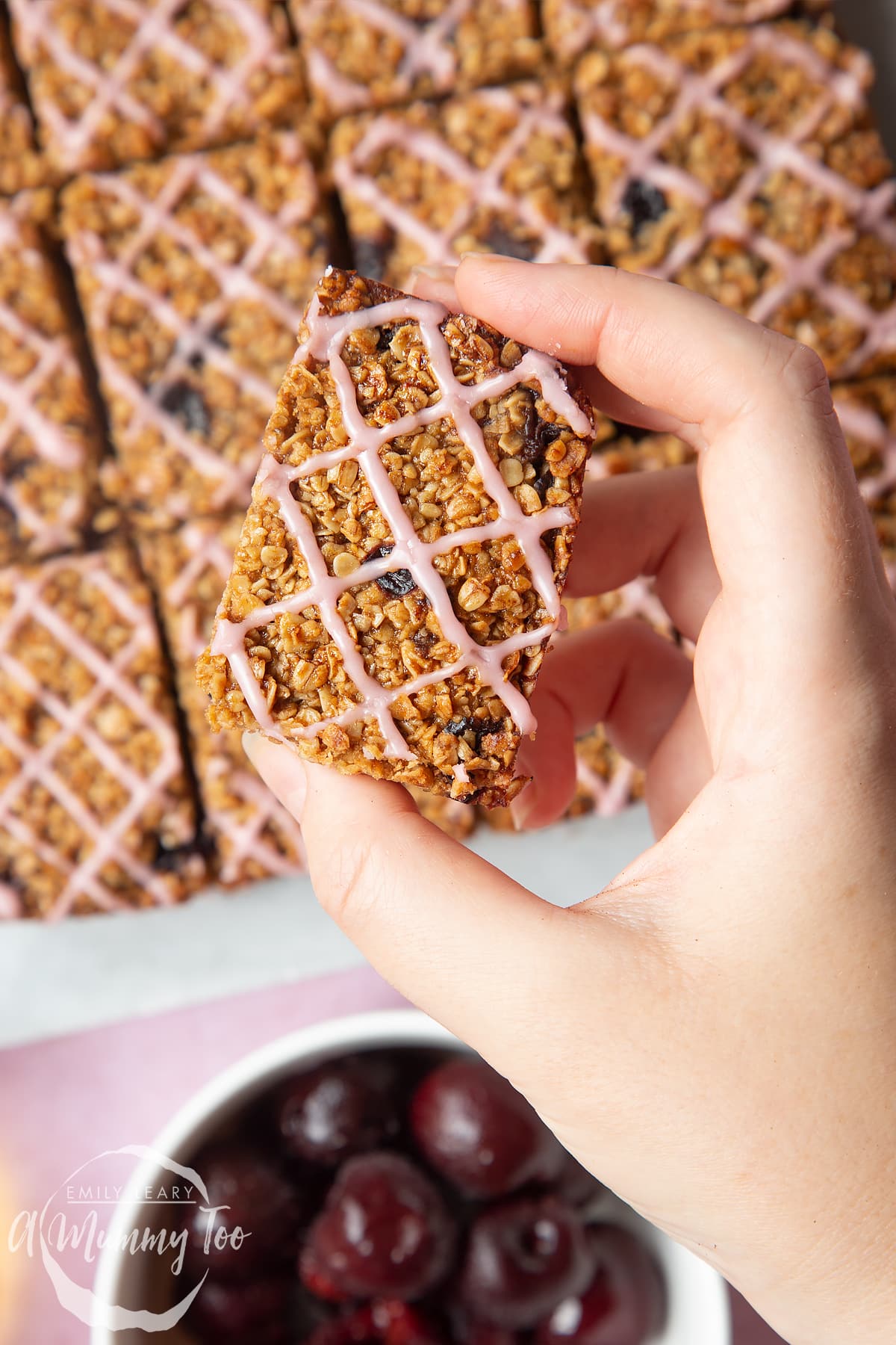 hand holding a cherry oat bar