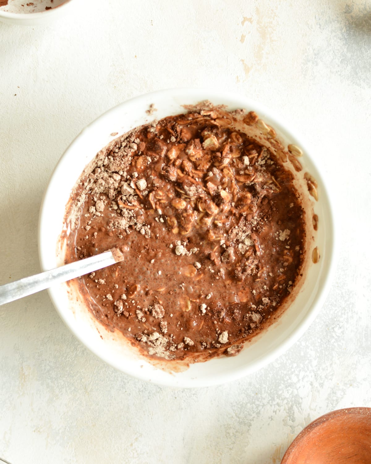a bowl of oats mixed with chocolate and milk