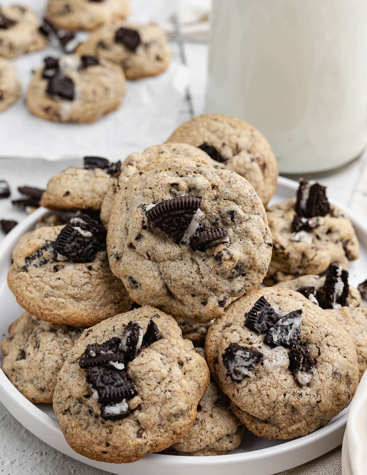 chocolate chip Oreo cookies stacked on a plate.