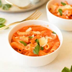 a bowl of pasta in tomato cream sauce