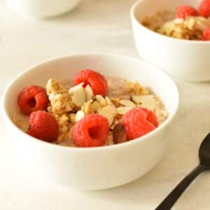 a bowl of overnight oats with raspberries