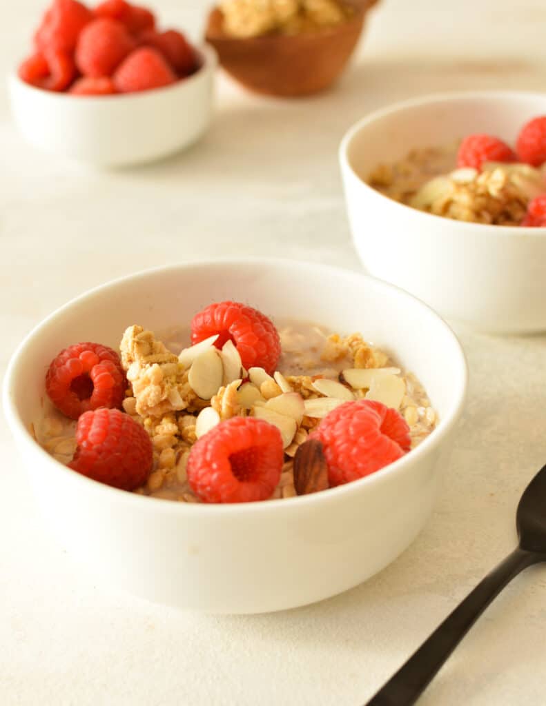 a bowl of overnight oats with raspberries