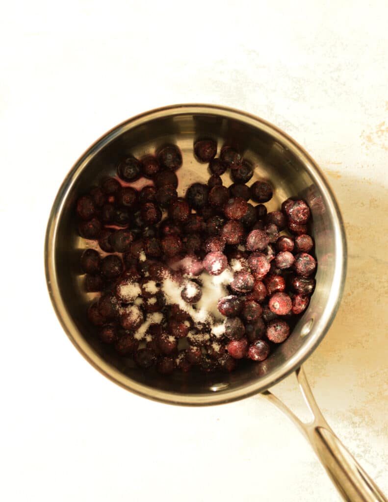 blueberries with sugar in saucepan.