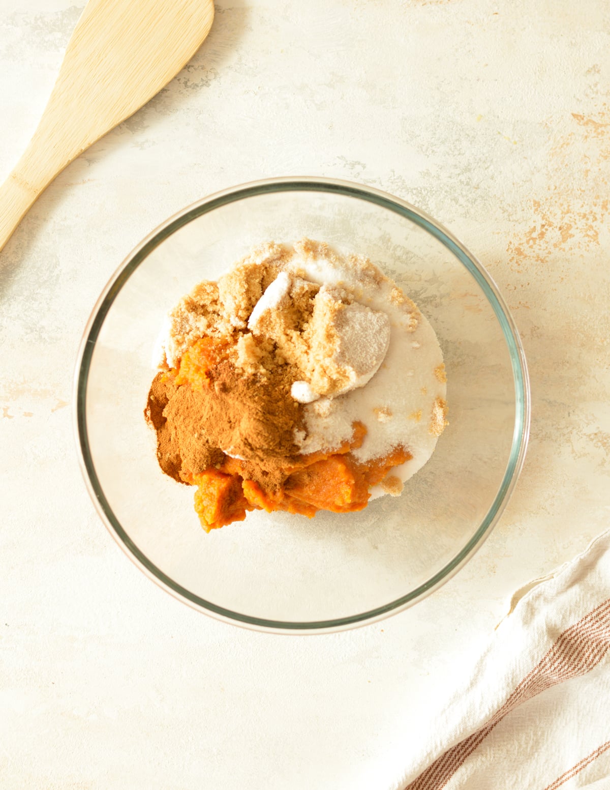 a bowl with pumpkin puree, spices, and sugar