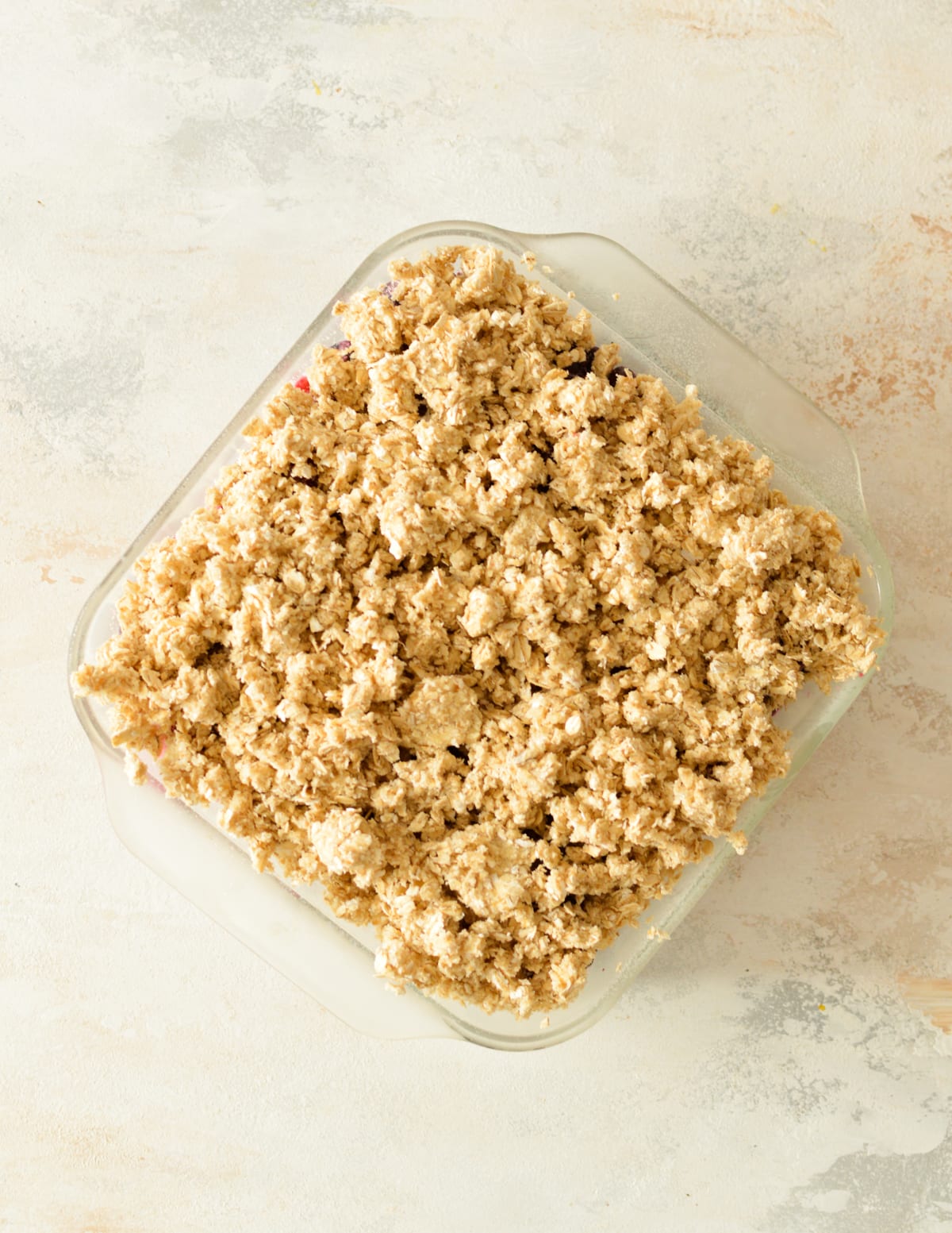 an unbaked berry crisp with an oat crumb topping