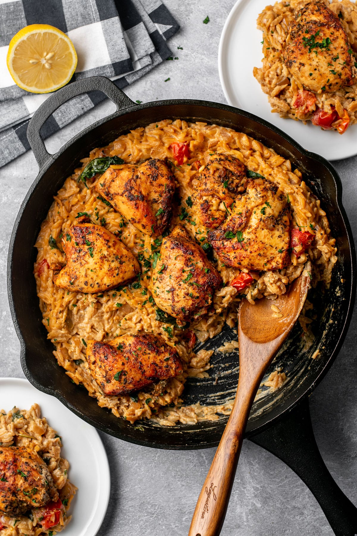 a skillet with creamy chicken and orzo.