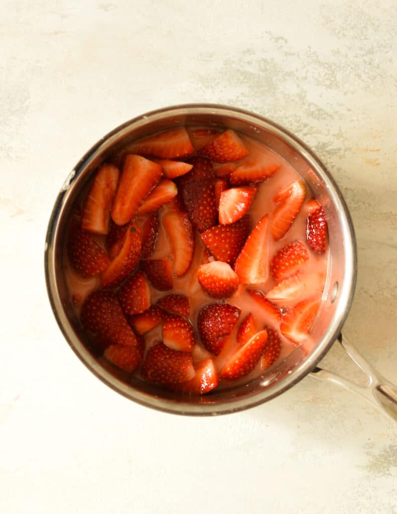 cut strawberries in saucepan.