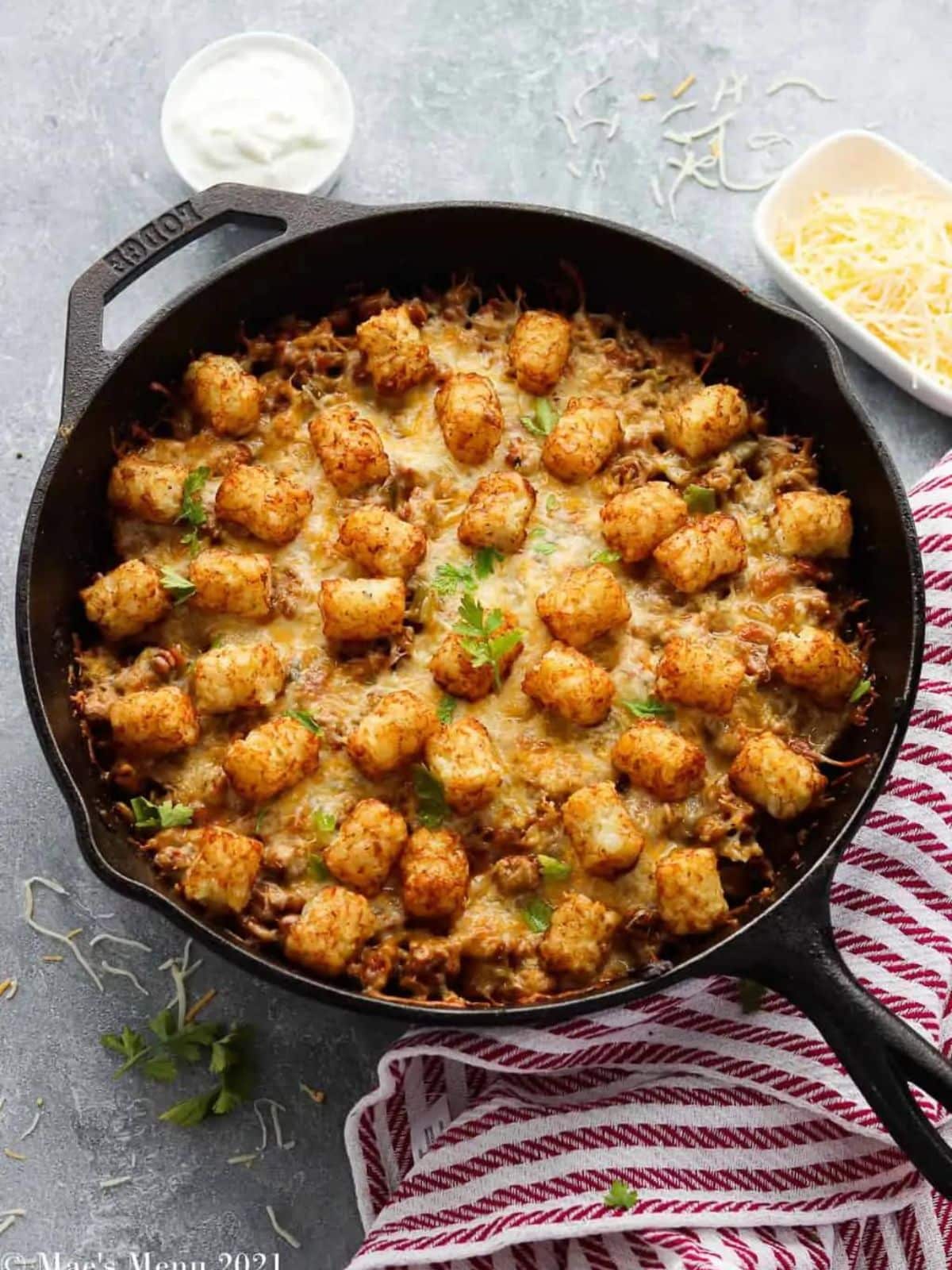 a skillet with tater tot casserole in it.