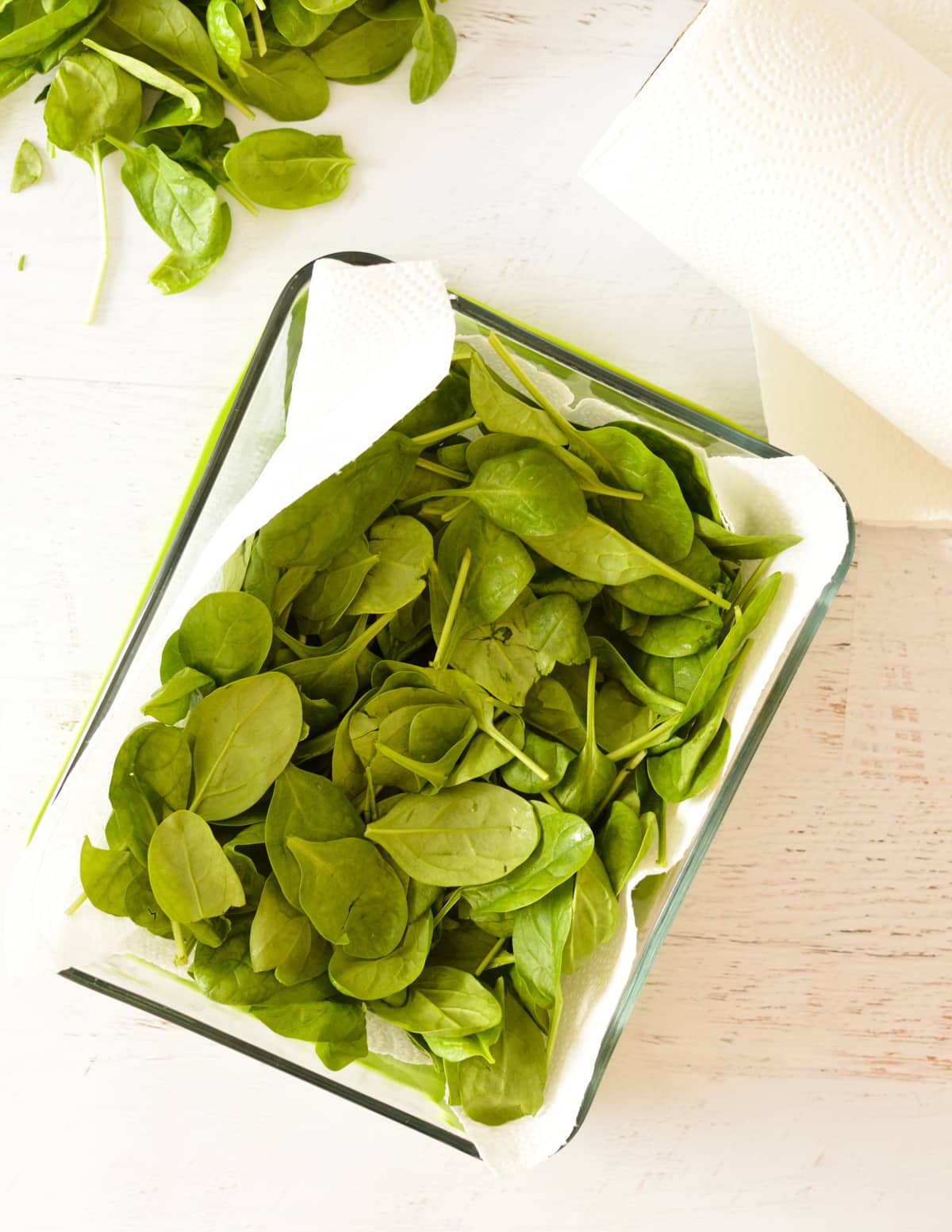 spinach in a paper towel in a container.