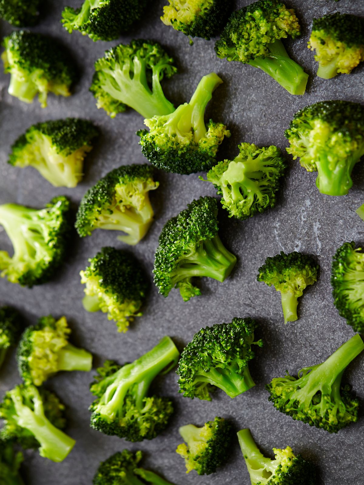 cooked broccoli florets on a sheet pan.