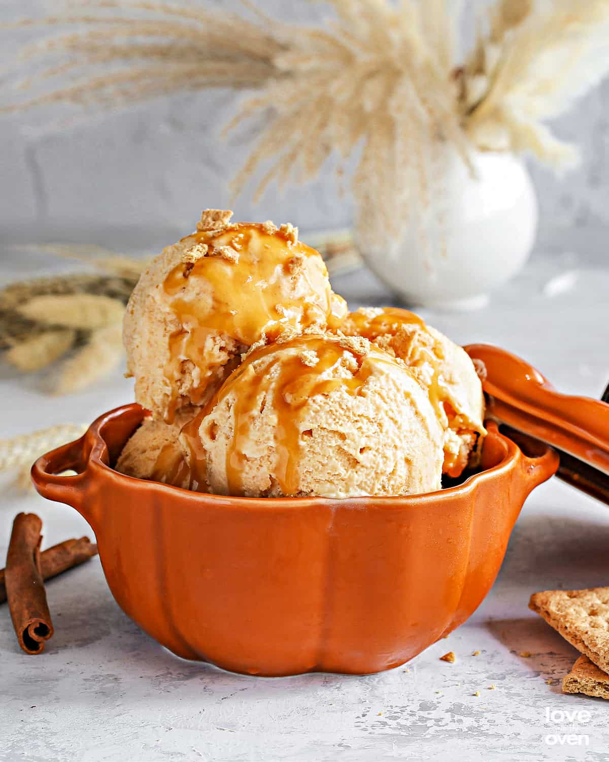 a bowl of pumpkin ice cream with caramel sauce.