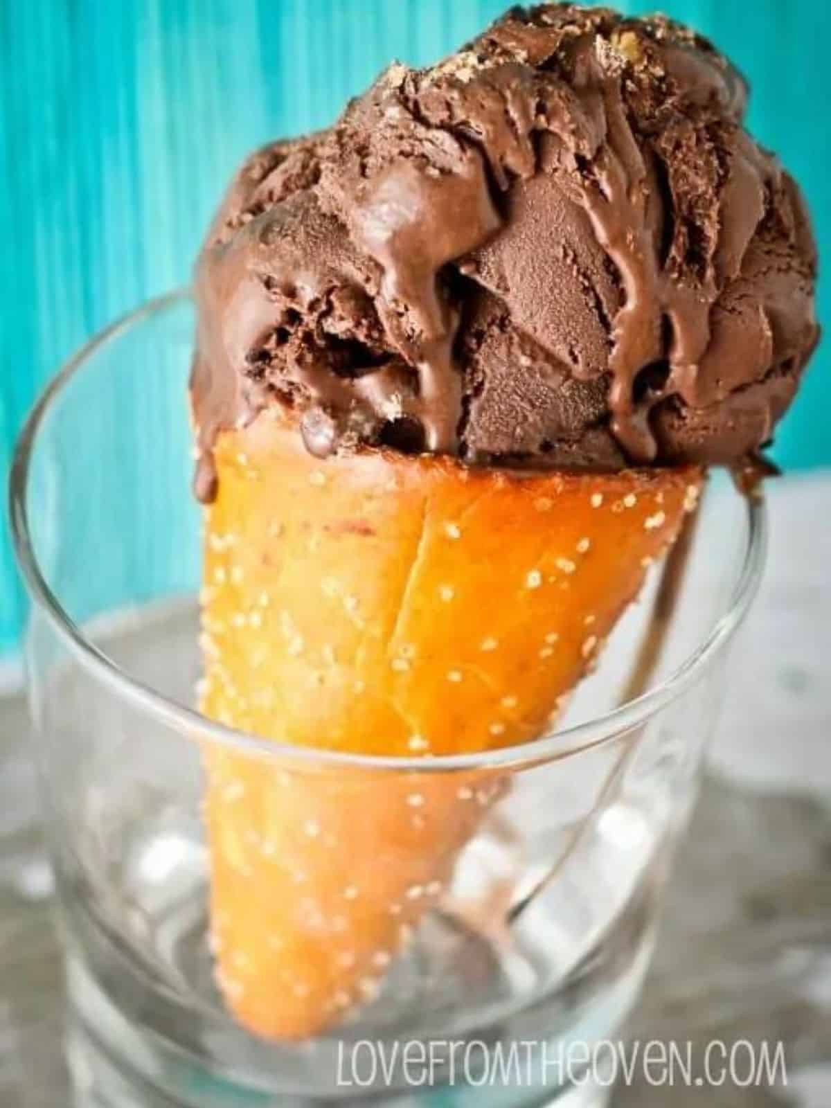 an ice cream cone with dark chocolate ice cream.