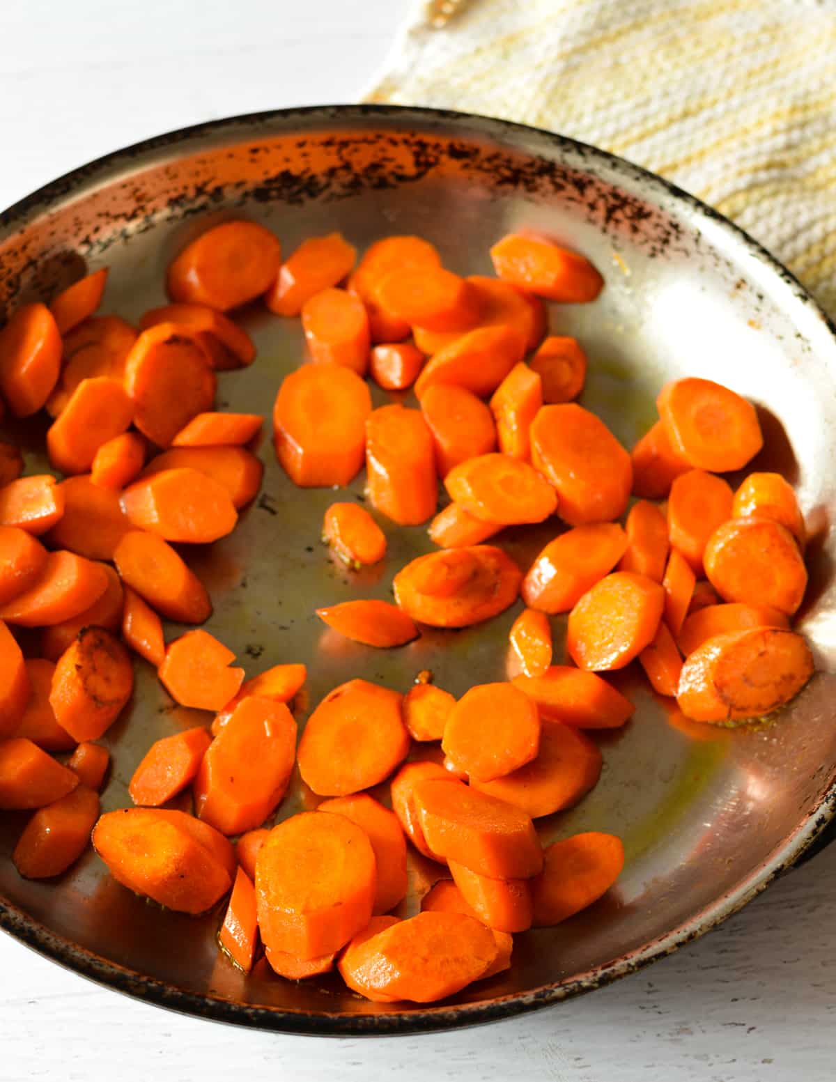 sauteed carrots in a skillet.