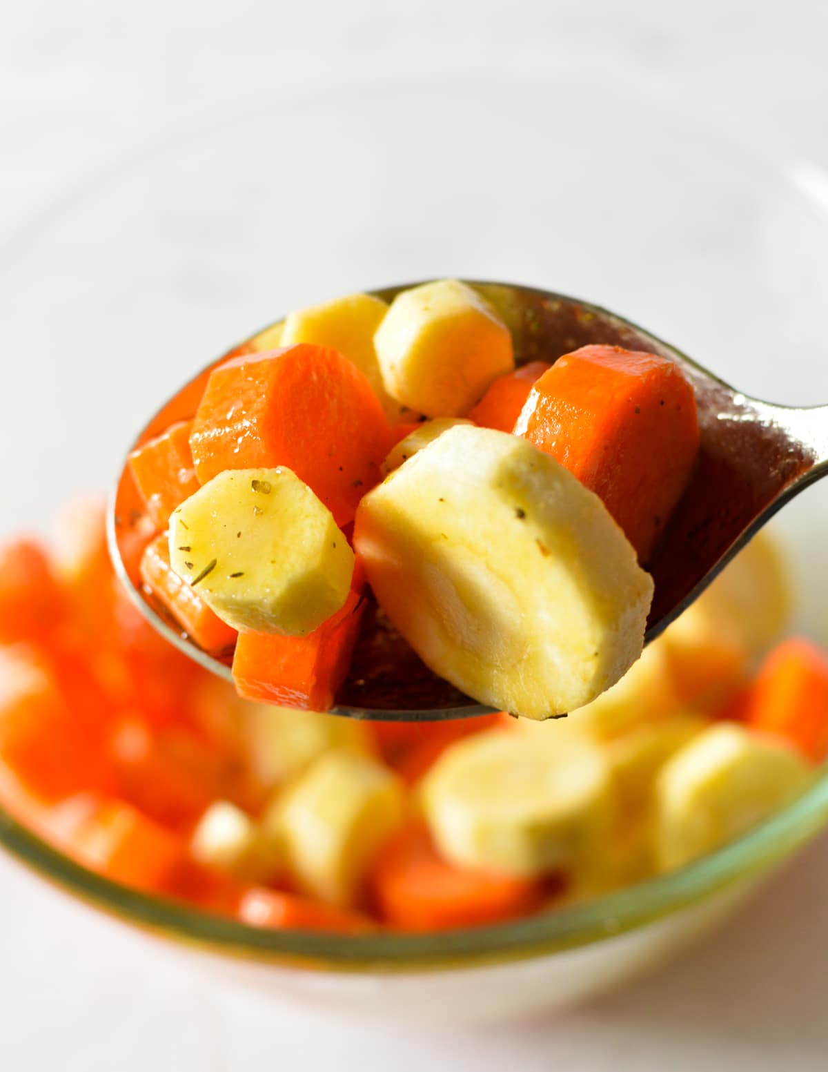 a spoonful of carrots and parsnips coated in honey.