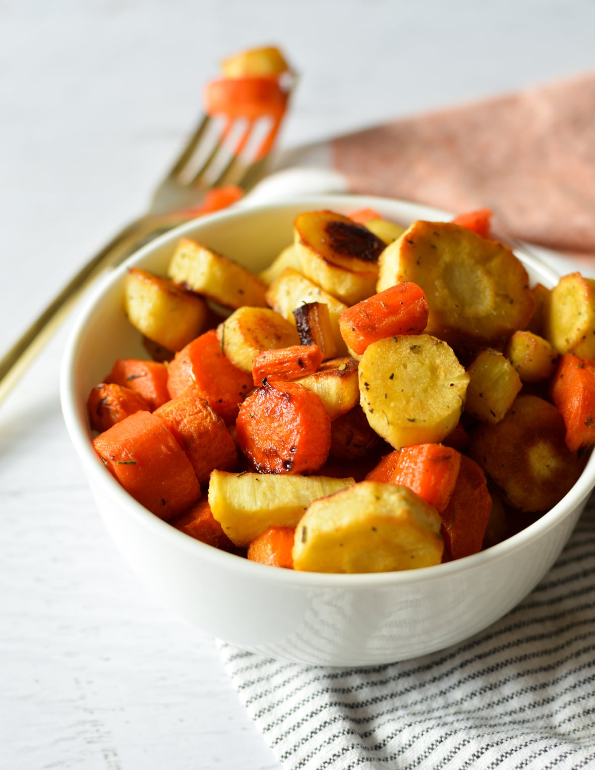 a bowl of roasted carrots and parsnips.