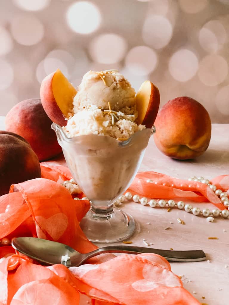 peach ice cream with fresh peaches on top.