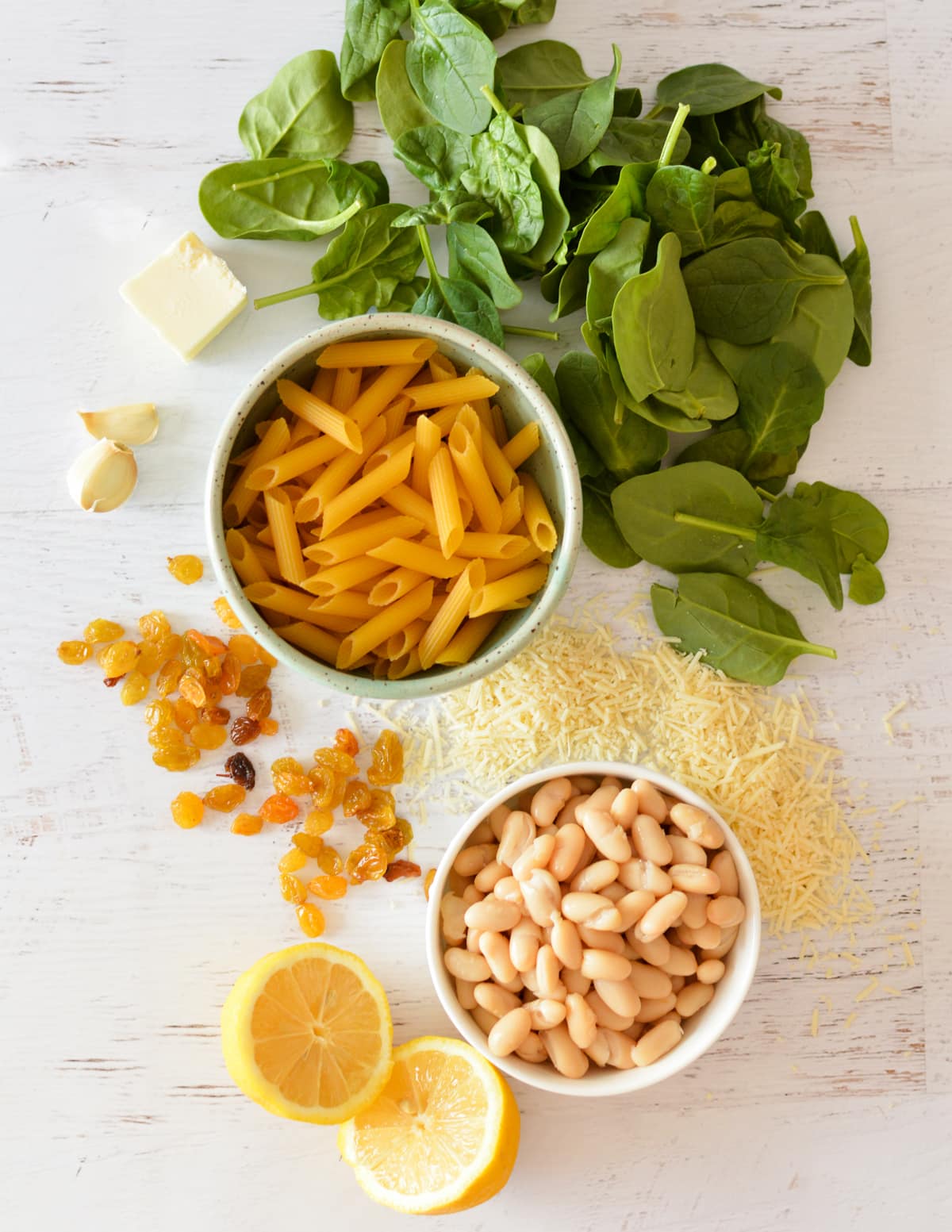 spinach, penne, golden raisins, parmesan, garlic, butter, and white beans. 