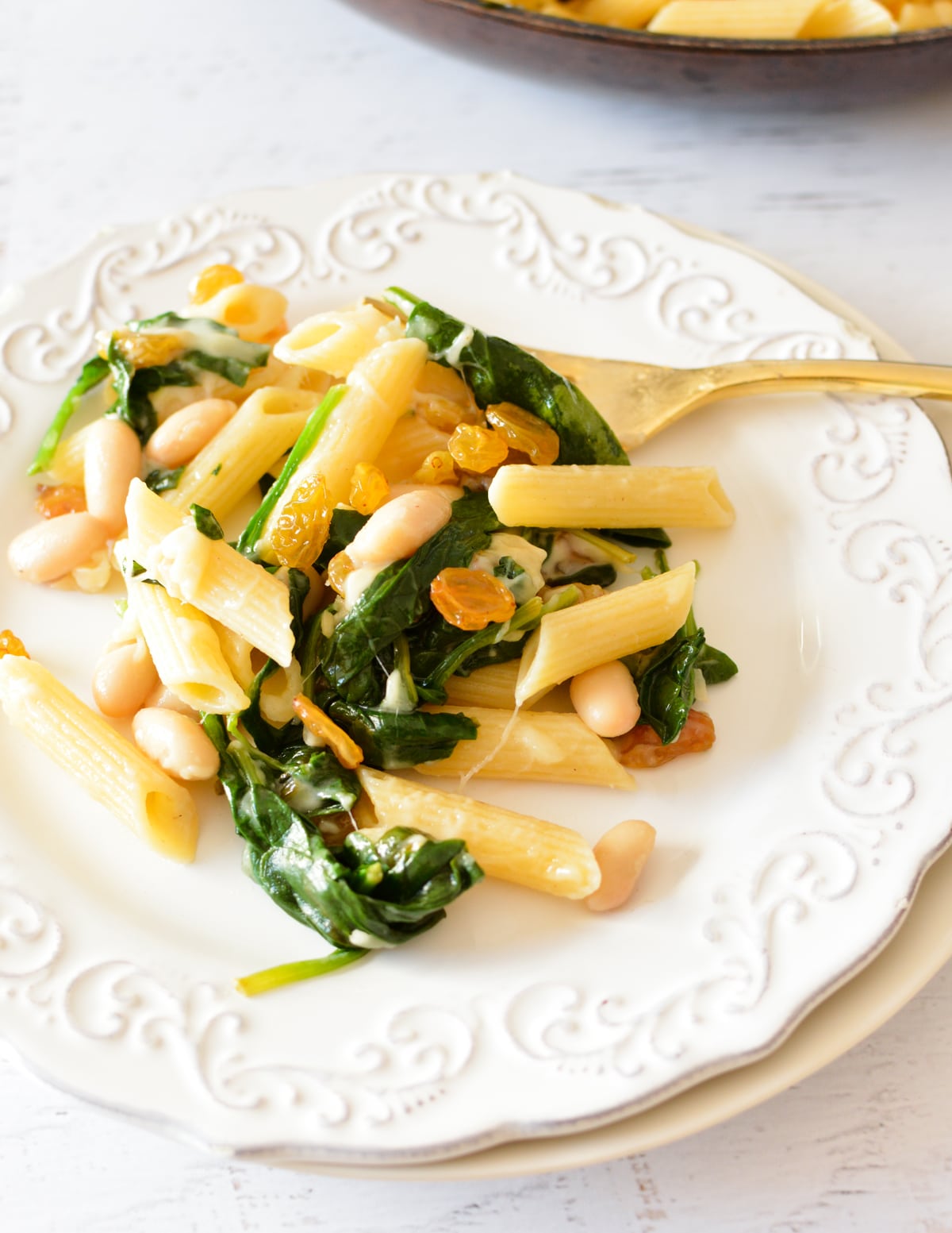 a plate of spinach pasta with parmesan.