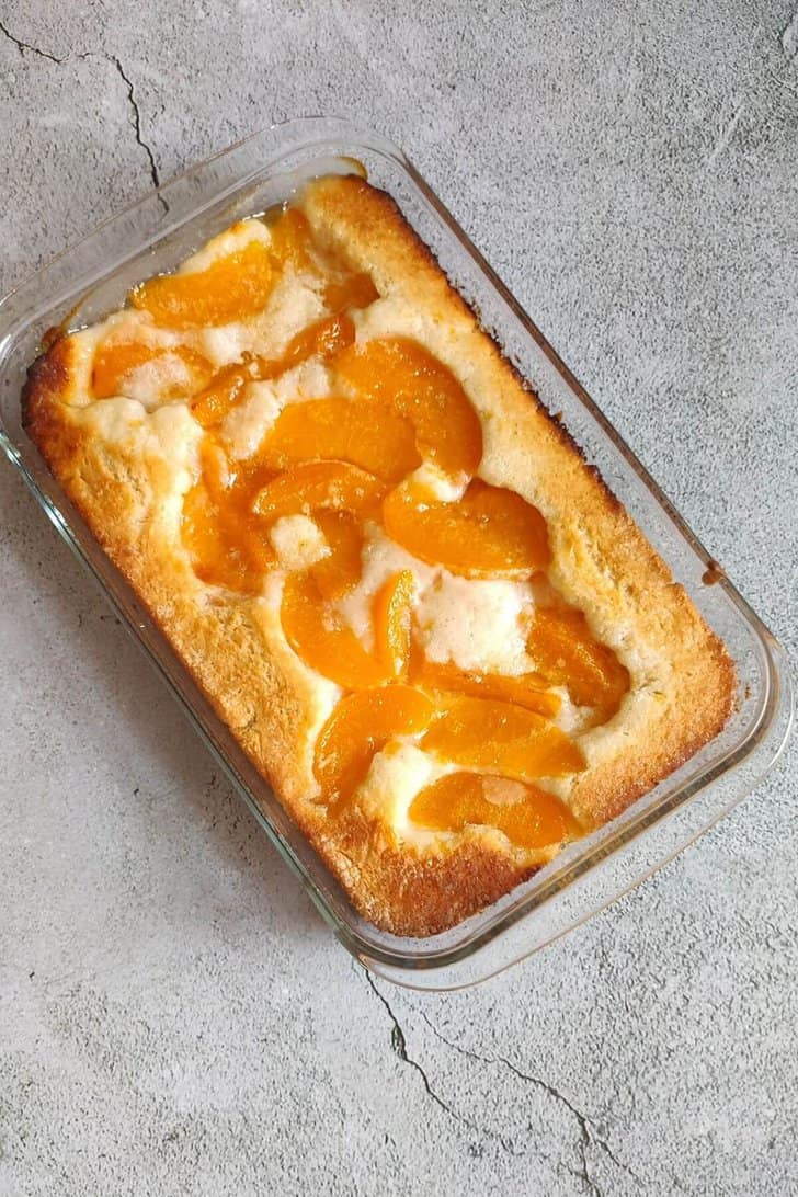 peach cobbler in a glass baking dish.