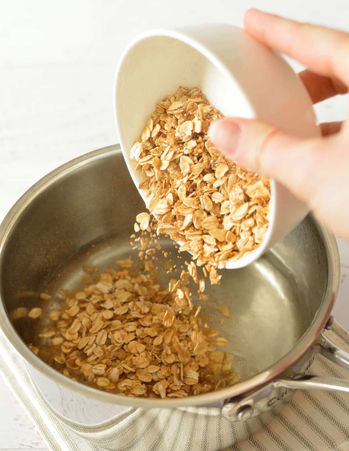 pouring the oats into a saucepan.