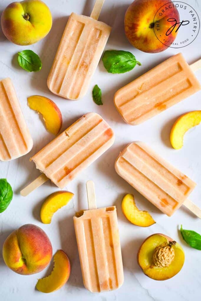 peach popsicles near peach slices.