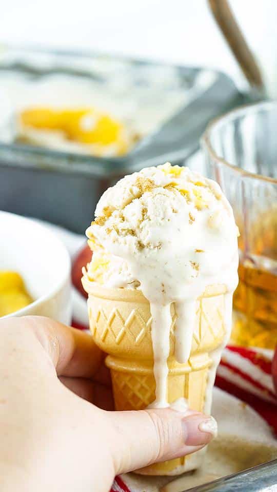 an ice cream cone with peach ice cream.