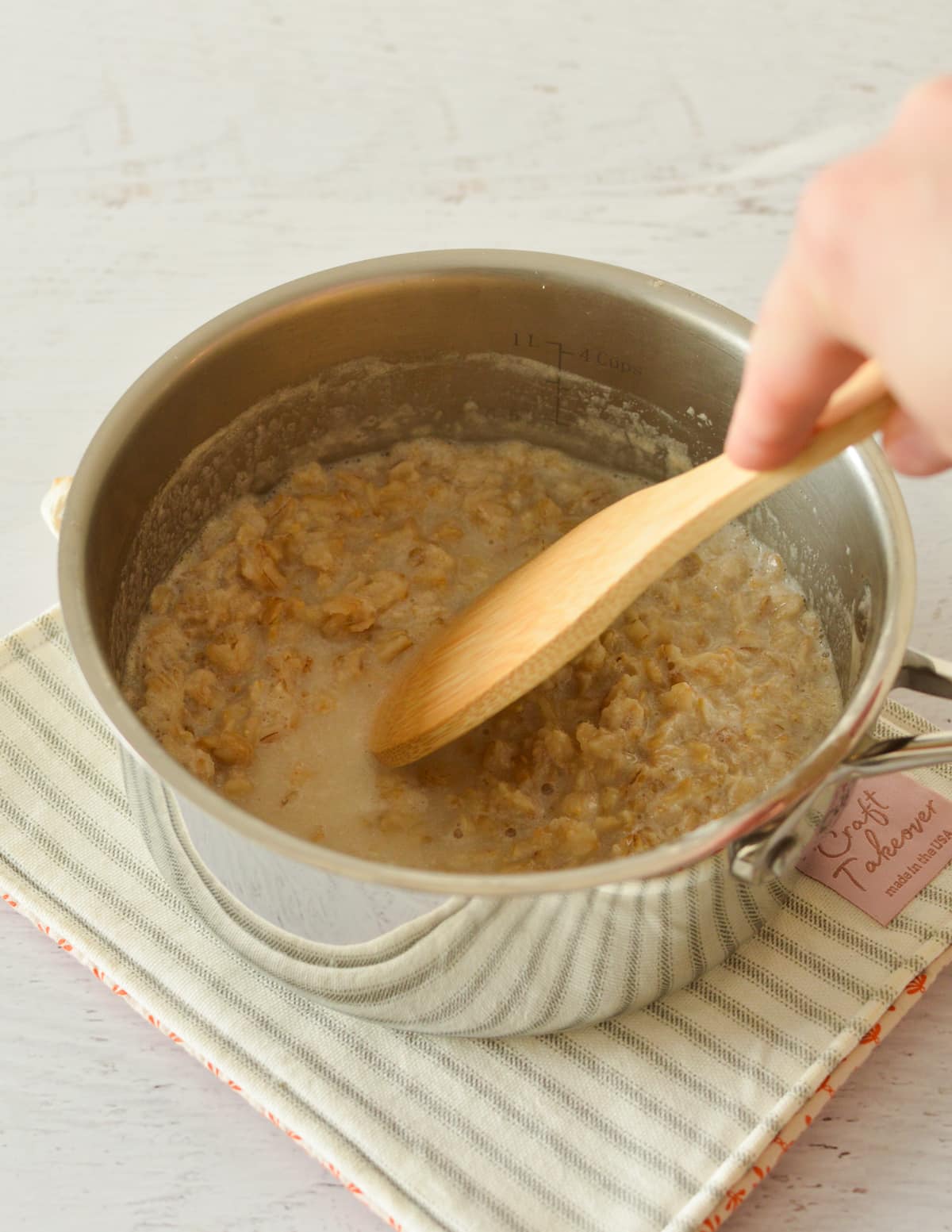 stirring oatmeal in a pan.