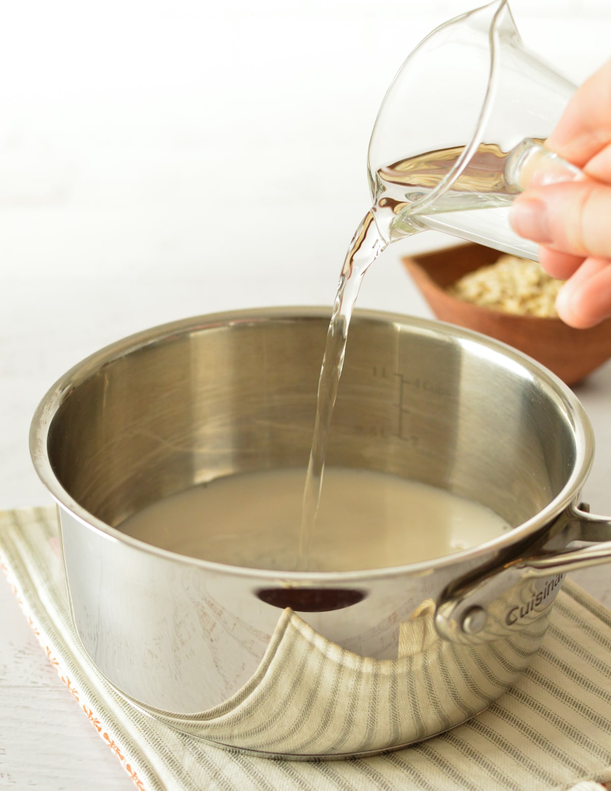 pouring water into a saucepan.