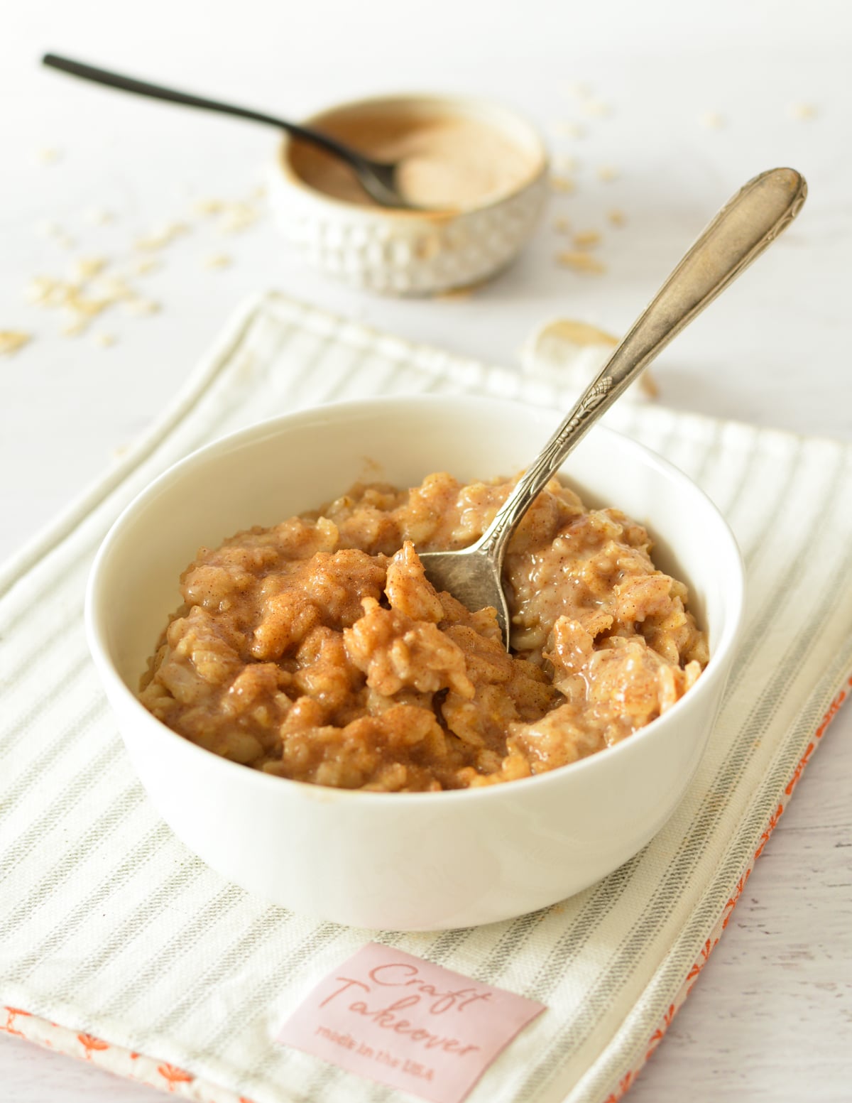 cinnamon oatmeal with a spoon in it.