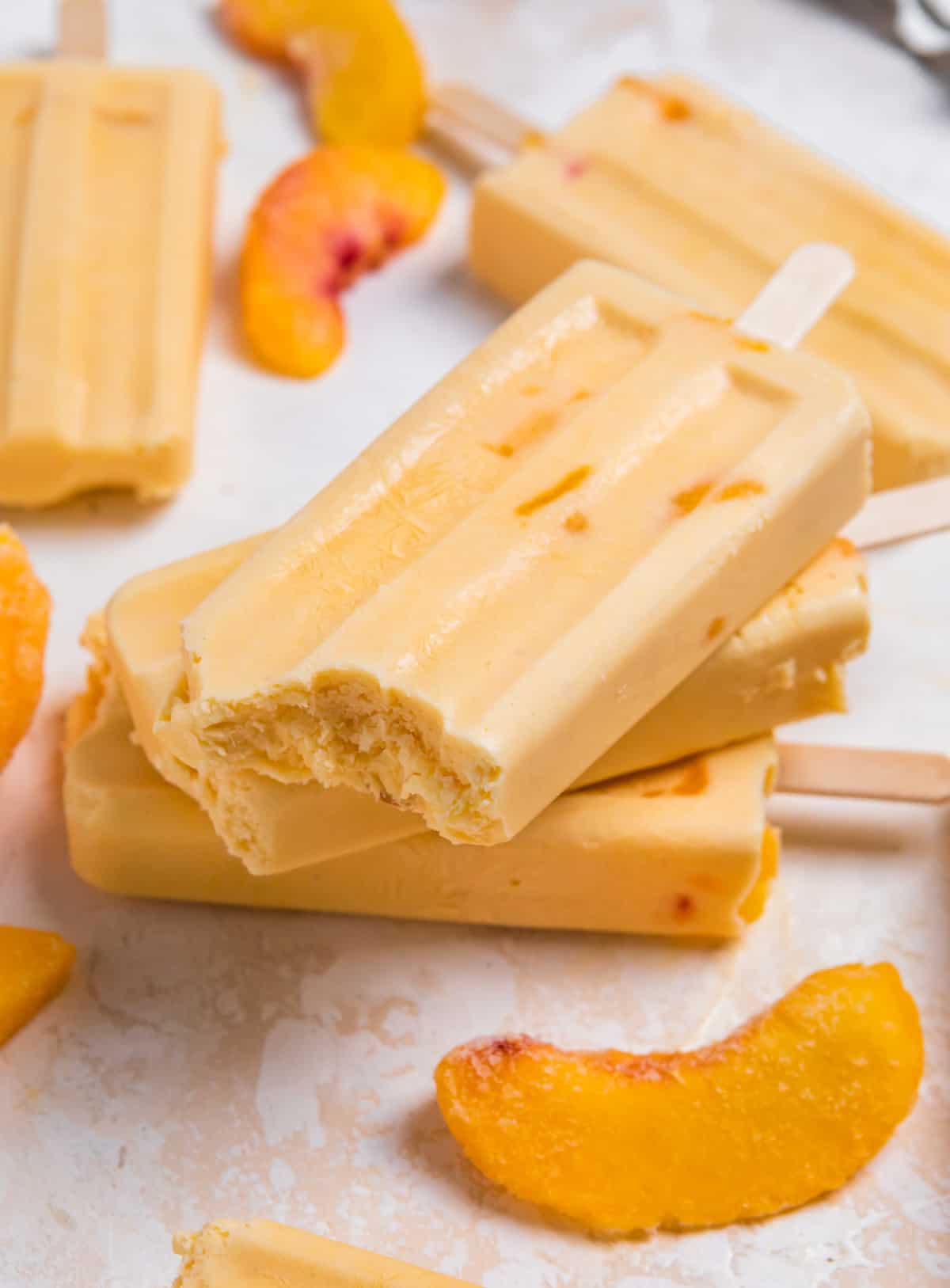 a stack of peach popsicles.