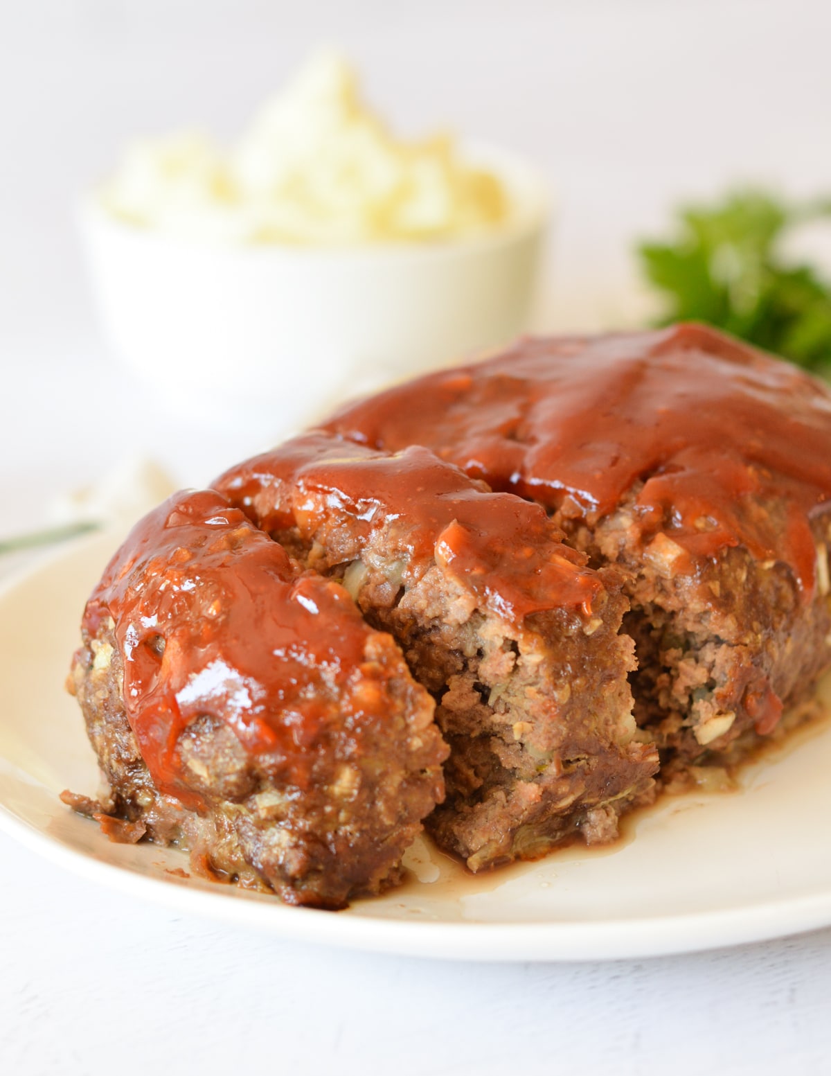 a sliced meatloaf with a ketchup glaze on top.