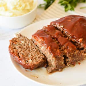 Sliced meatloaf on a plate.