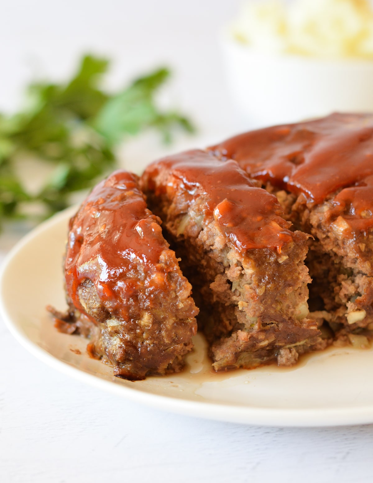 a sliced meatloaf with glaze on top.