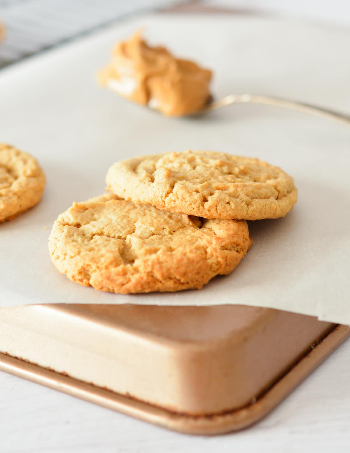 two peanut butter cookies on a sheet pan. 