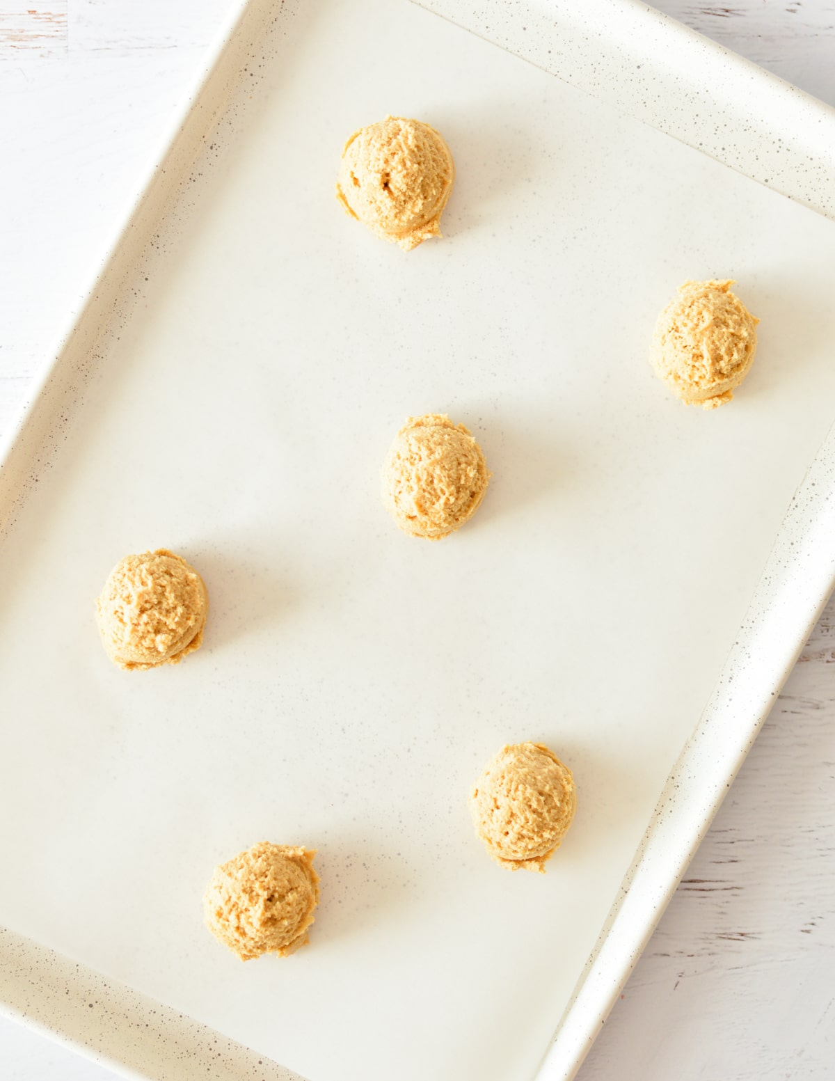peanut butter cookie dough balls on sheet pan.