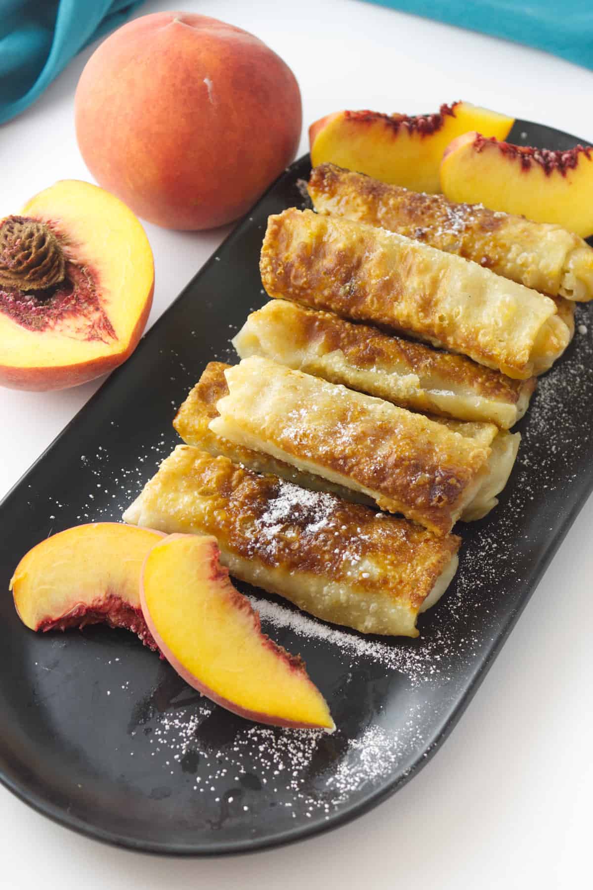 a plate of peach egg rolls.