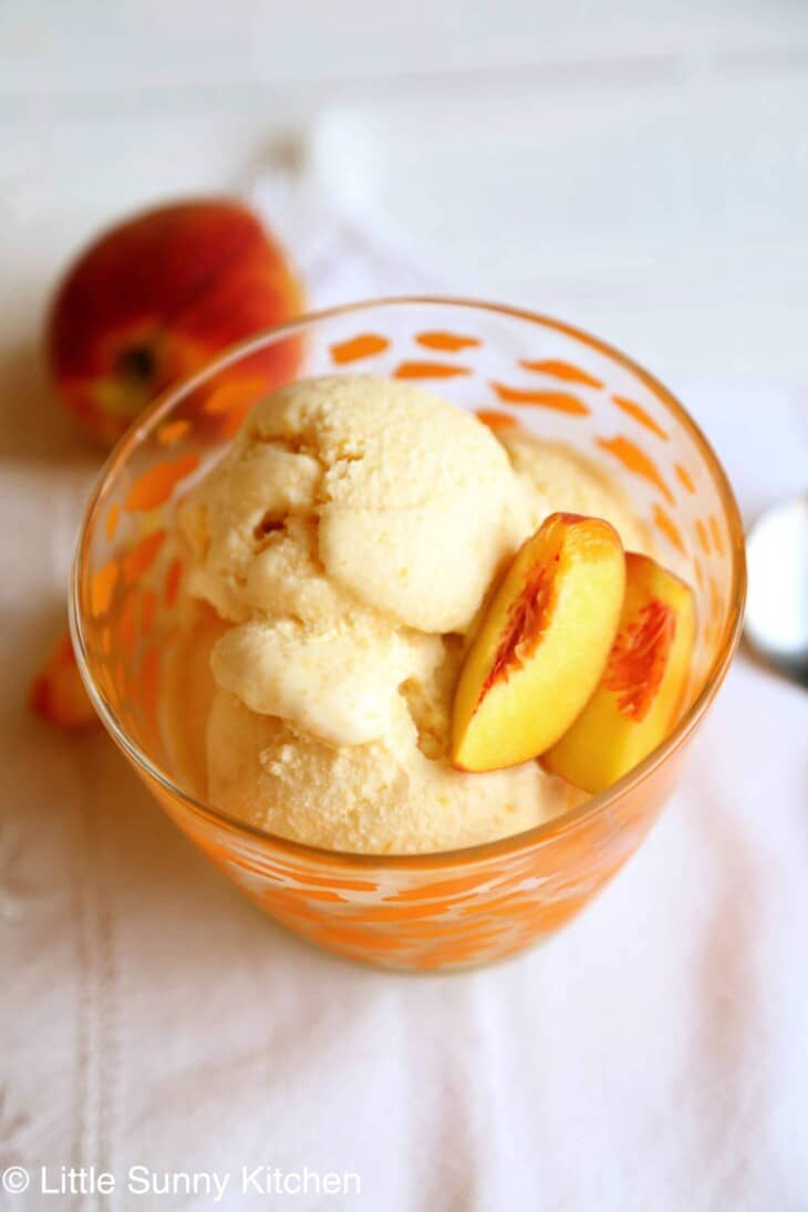 peach ice cream in a bowl.