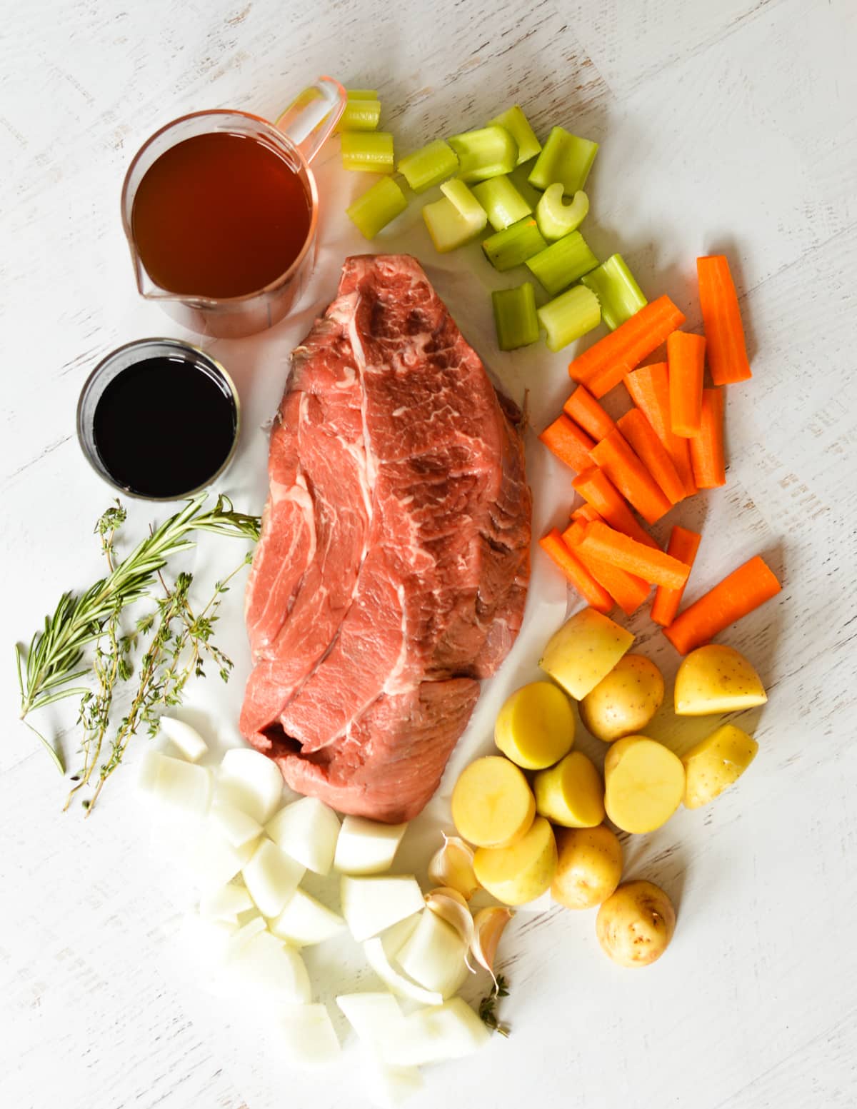 chuck roast, carrots, onions, celery, potatoes, beef broth, red wine, garlic, herbs.
