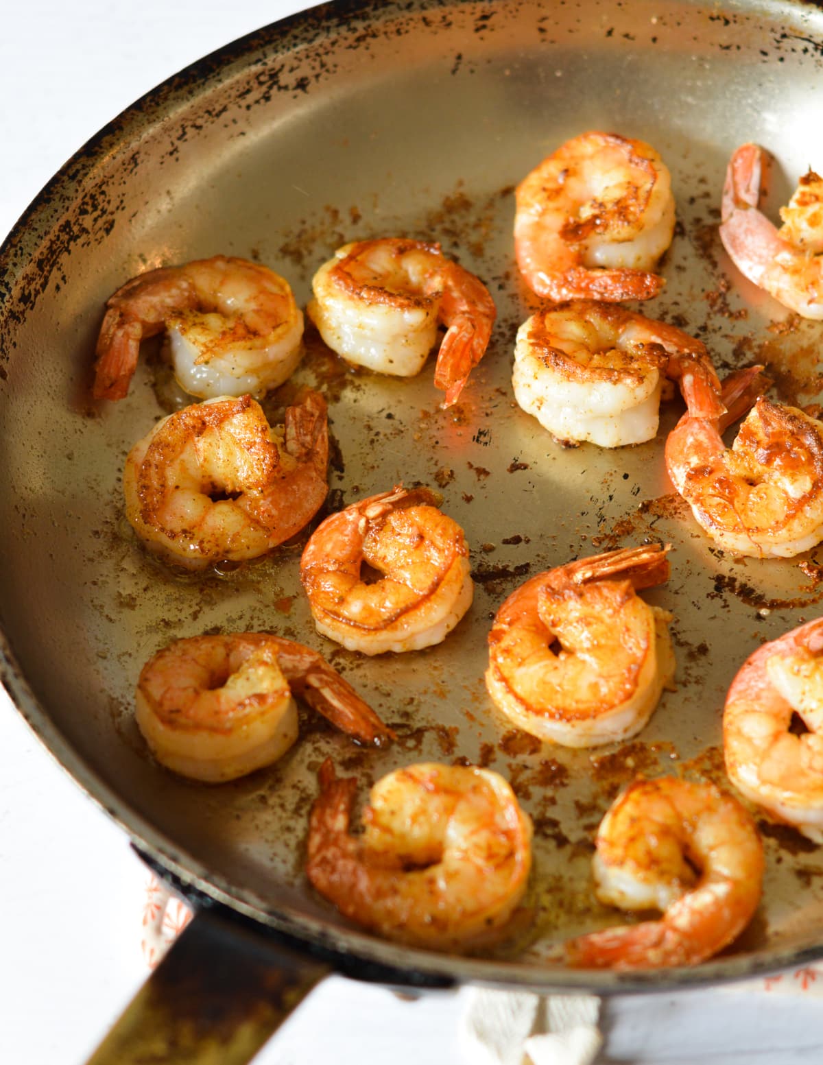 seared shrimp in a skillet.