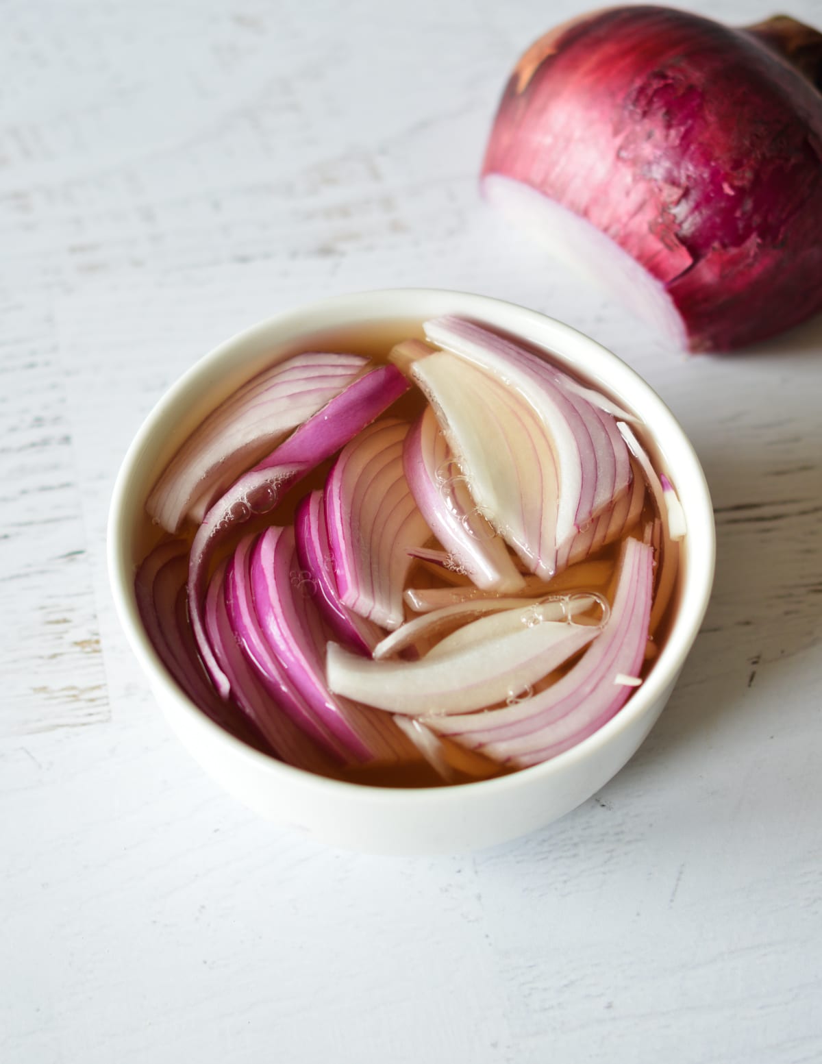 red onion in a bowl with vinegar and honey. 