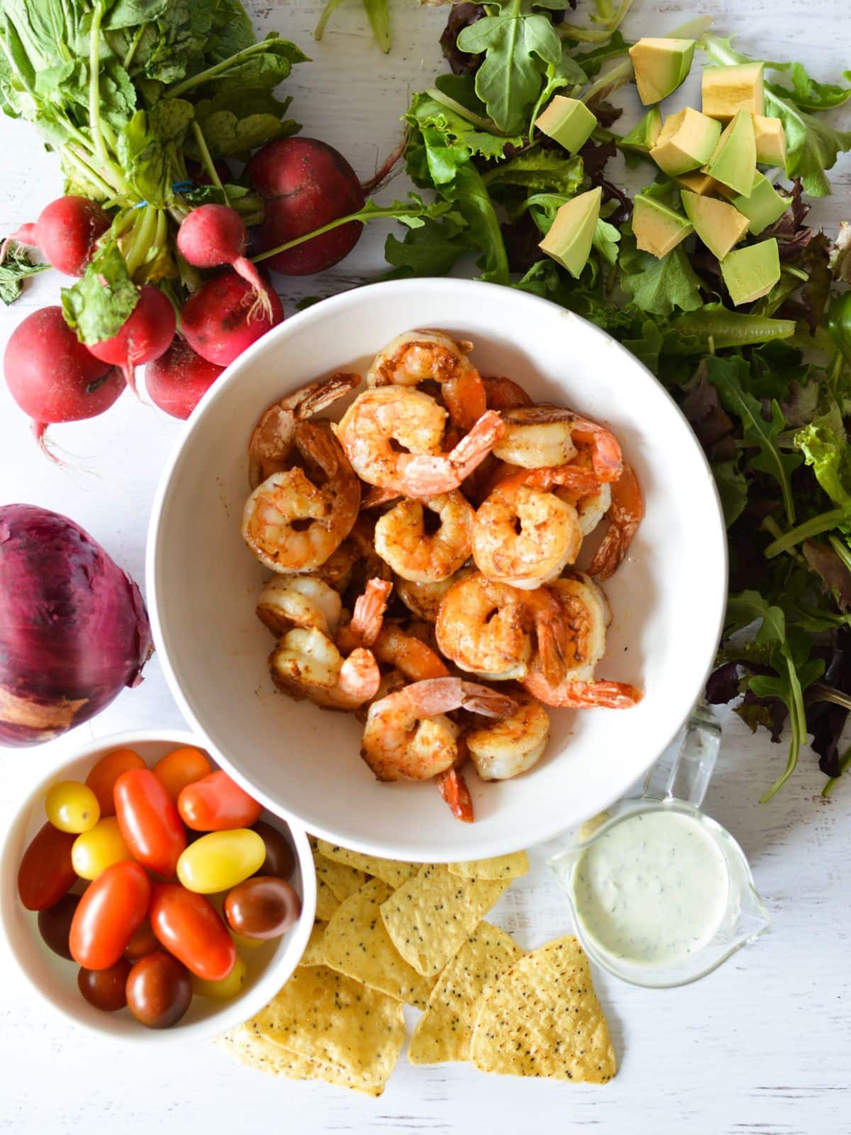 shrimp, greens, tomatoes, red onion, chips, radish, green goddess dressing. 