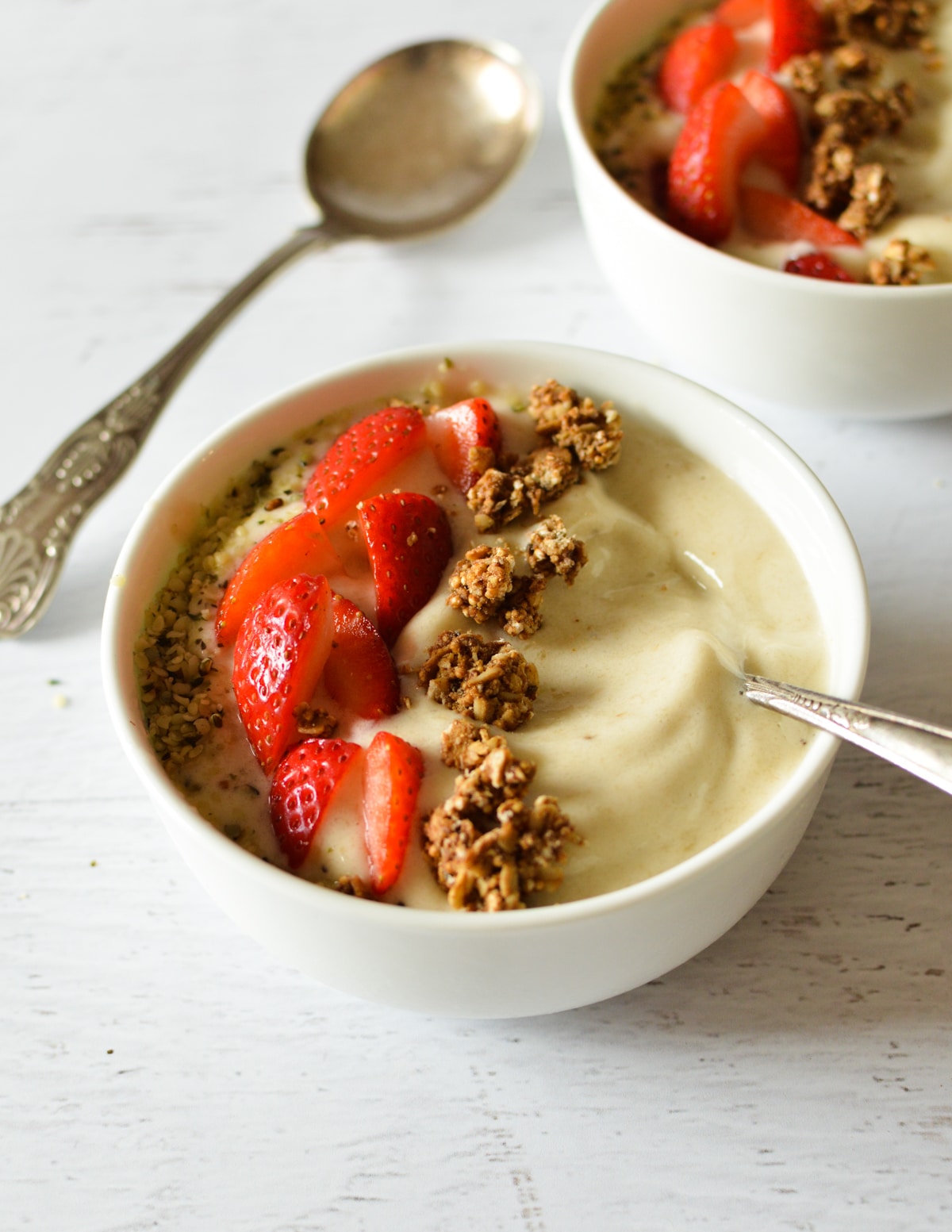 banana smoothie bowl with fruit and granola.