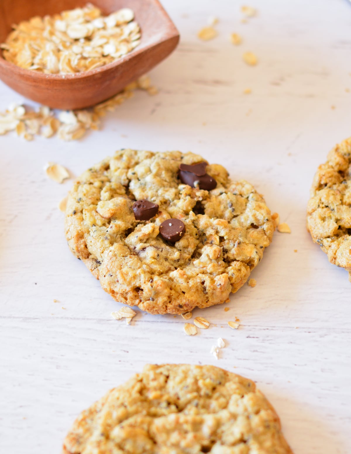 oatmeal cookie next to rolled oats. 