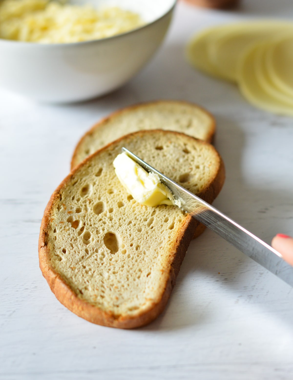 knife with butter on a slice of bread.
