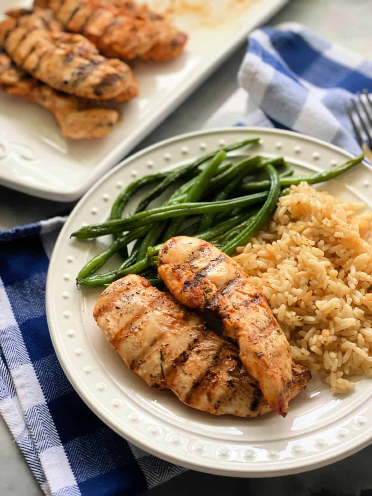 grilled chicken with rice and green beans.