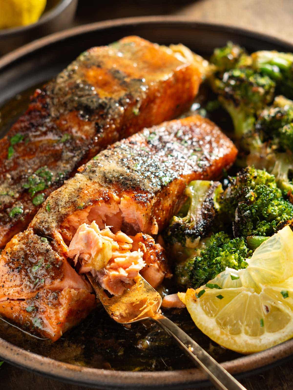 a forkful of salmon with broccoli.