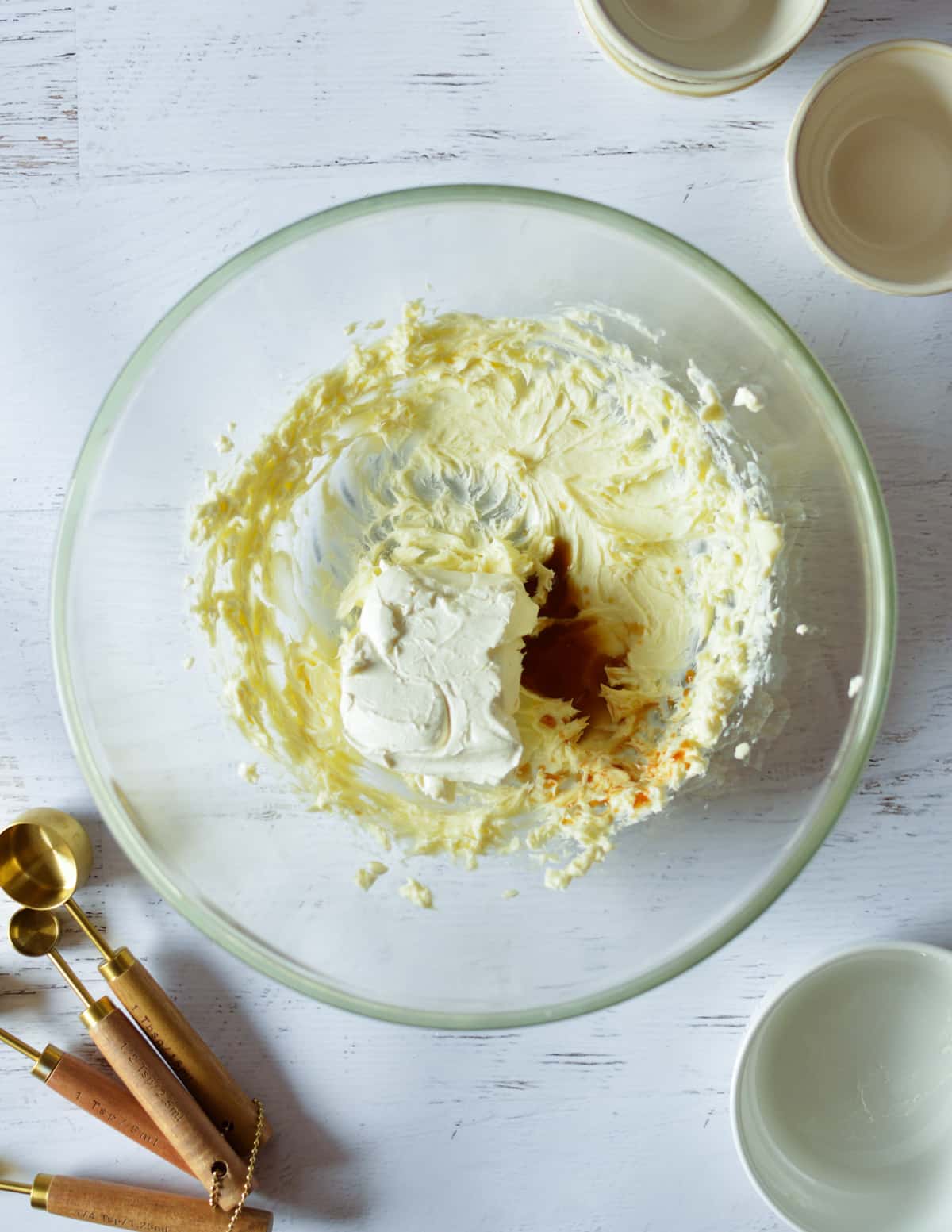 a bowl with whipped butter, cream cheese, and vanilla.