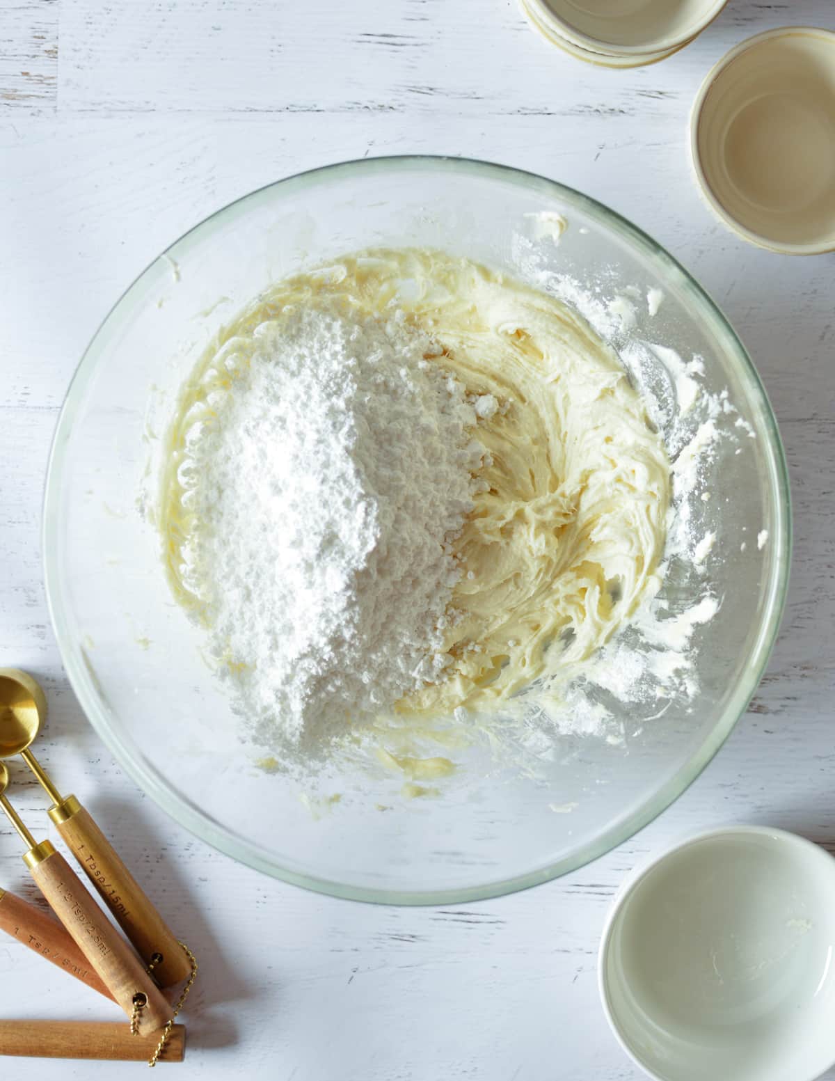 cream cheese frosting with powdered sugar on top.