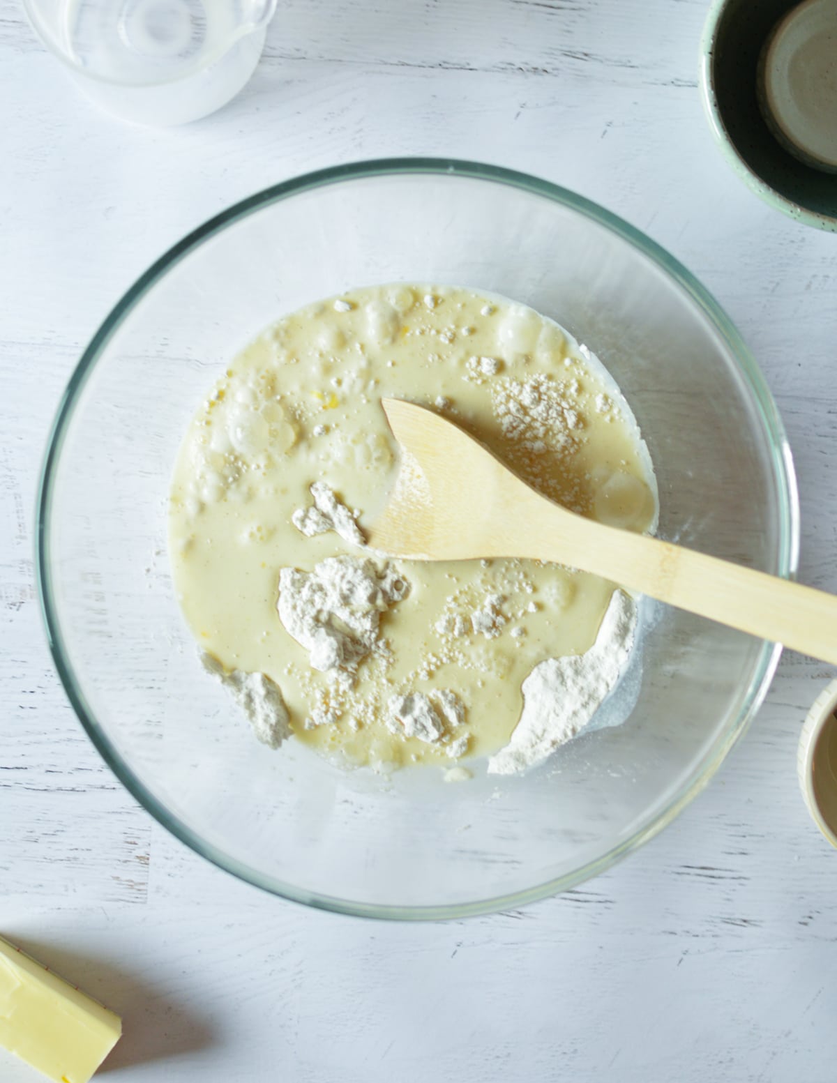 a bowl with flour, milk, and egg in it.